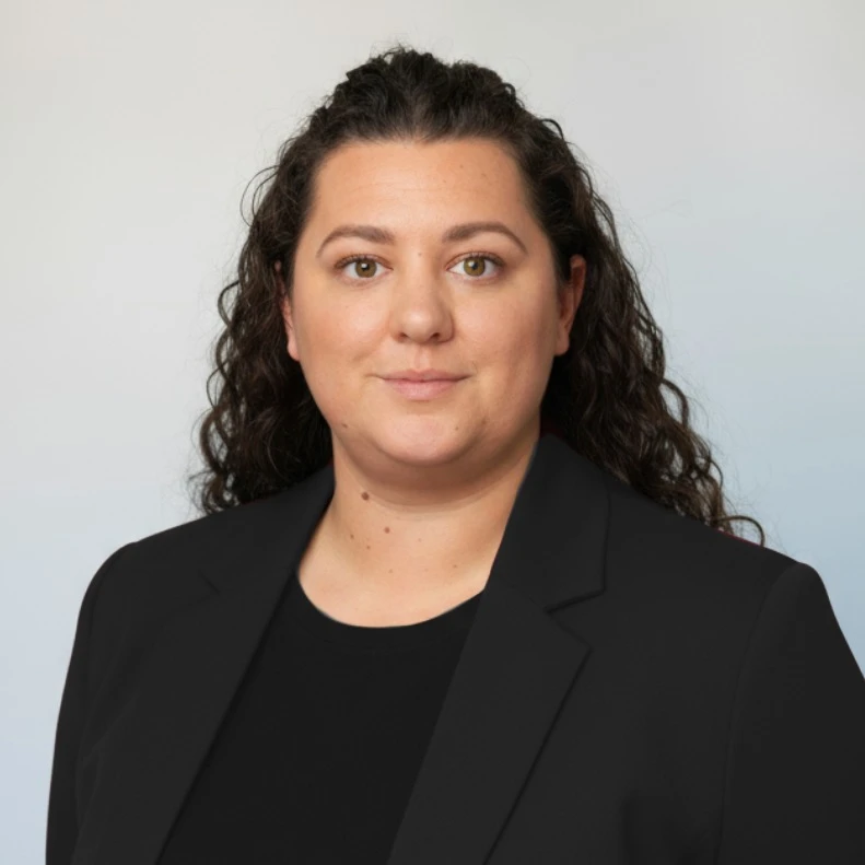 Professional headshot of Rachel Hardcastle, smiling and wearing business attire against a neutral background.