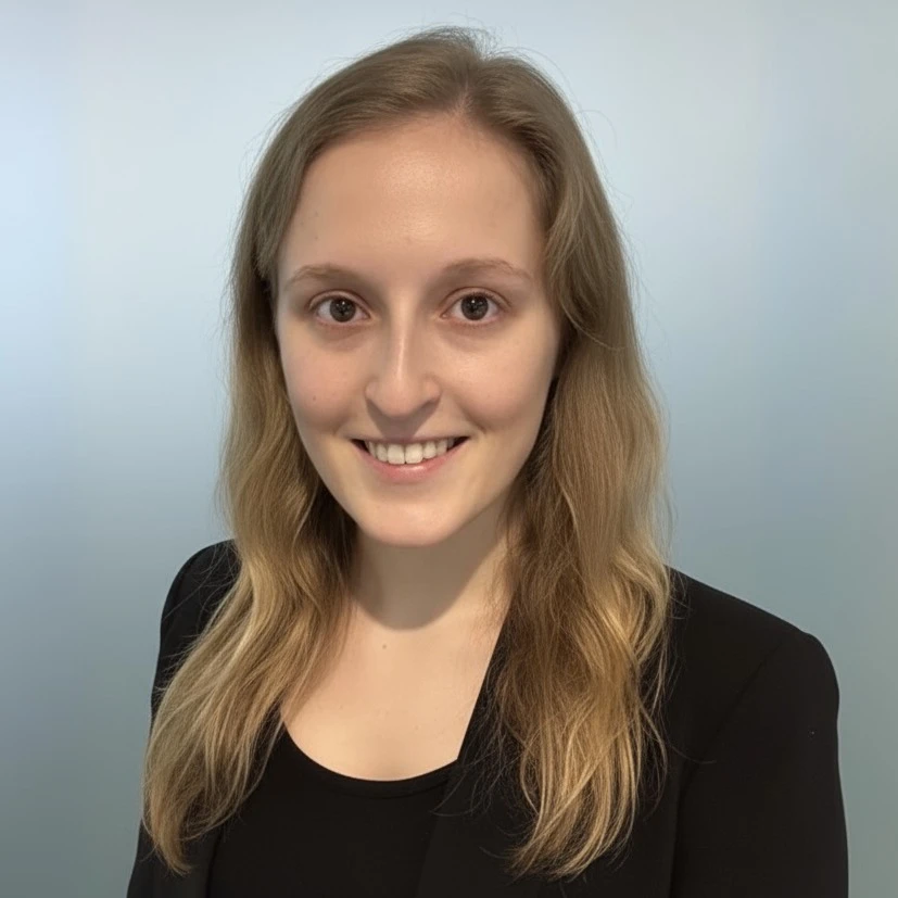 Professional headshot of Rebecca Small, smiling and wearing business attire against a neutral background.