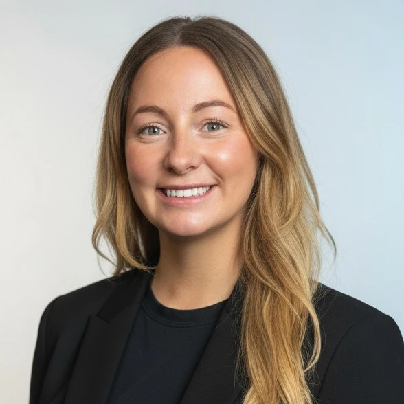 Professional headshot of Sarah Louise Higgins, smiling and wearing business attire against a neutral background.